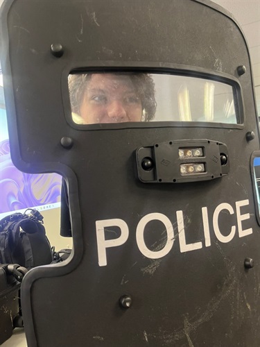 Teen holding police shield