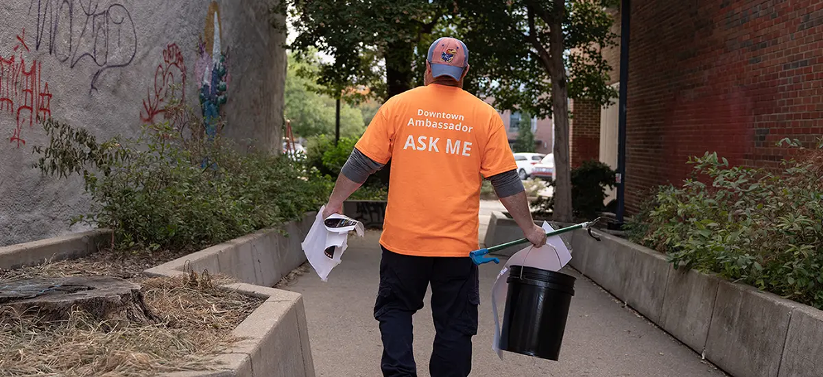 Downtown Ambassador carrying cleaning supplies